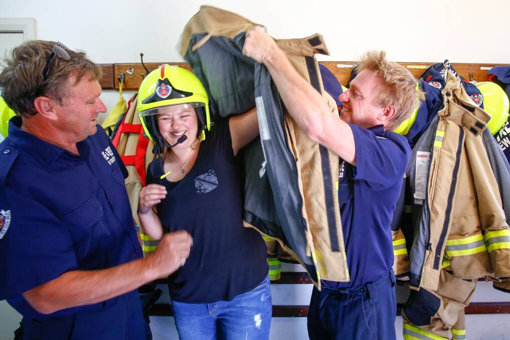 Perfect candidate: Corrimal Fire Station is targeting females like 25-year-old Lauren Cummings to apply to become a part-time retained fire-fighter. With Mark Cummings and Paul Dorin. Picture: Adam McLean