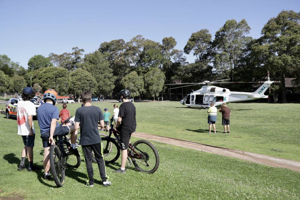 Paramedics and the Toll rescue helicopter at Kirra Mine Oval treating a male mountain bike rider who injured himself while riding at Mount Keira on October 22. Picture: Adam McLean