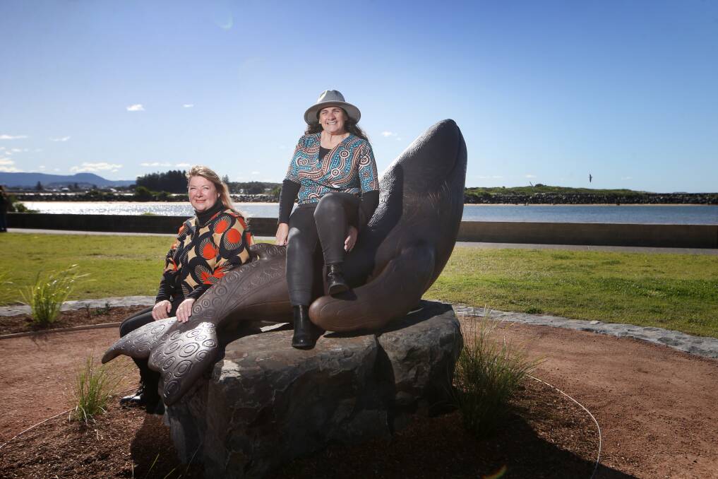 Julie Squires and Jodi Edwards at the unveiling of Burri Burri, the latest sculpture installed on the Lake Illawarra Art Trail. Burri Burri was created by shaping the whale and coolamon forms in polystyrene foam and coating them in wax before hand-carving into the surface. The pieces were then cast in bronze. Overall, the fabrication process took eight months. Picture by Sylvia Liber.