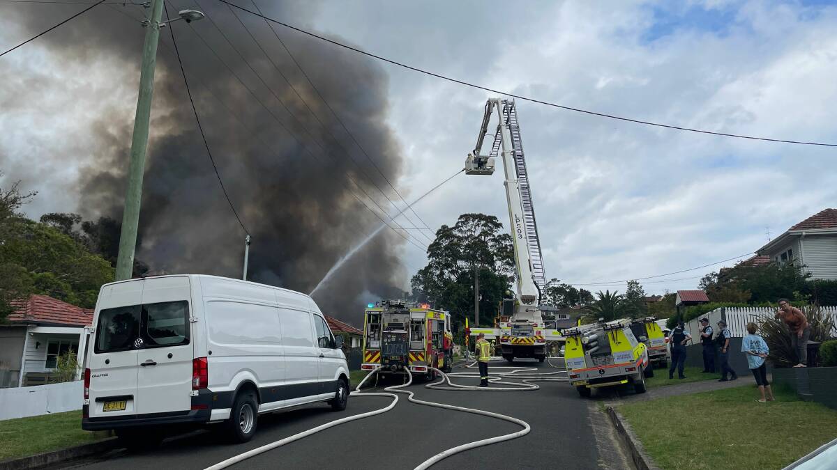 Dozens of firefighters attend a ferocious house fire in West Wollongong on Wednesday. Picture by Robert Peet.