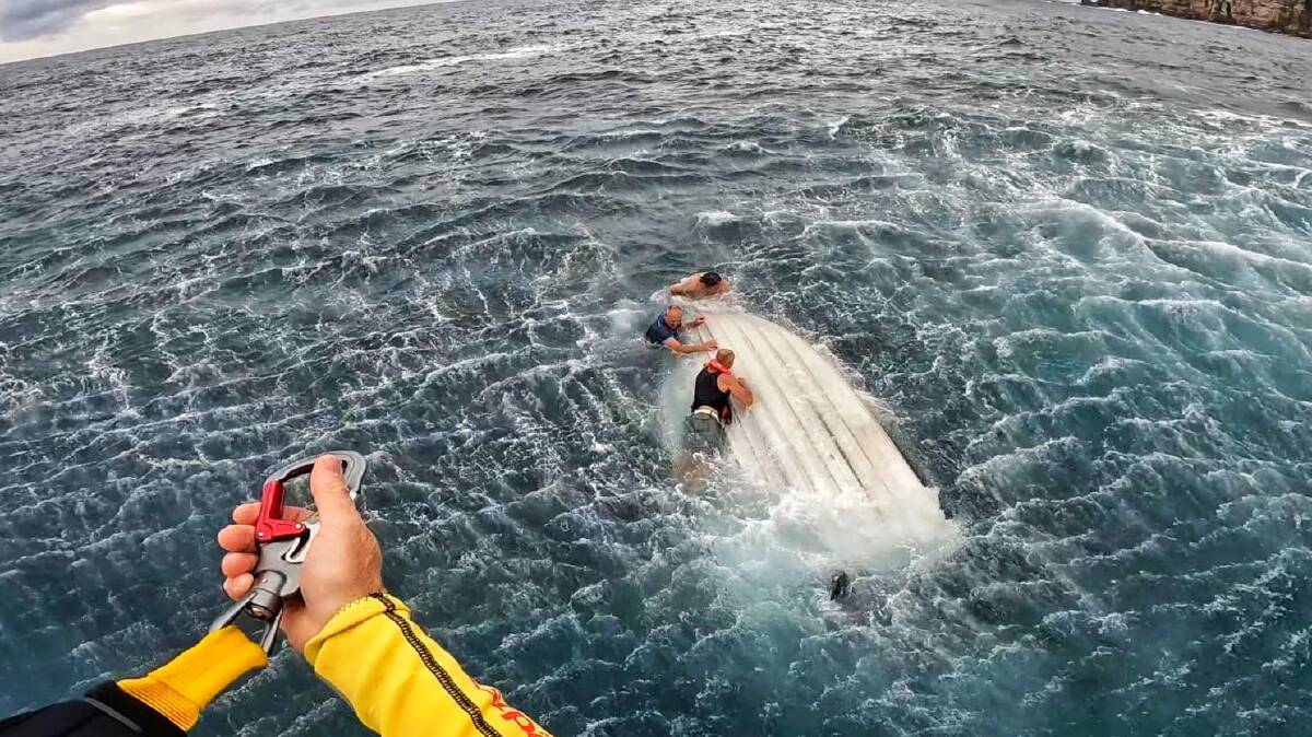 Multiple emergency services were called to rescue three fishermen on Wednesday after their tinny overturned near Wedding Cake Rock. Picture by Westpac Life Saver Rescue Helicopters.