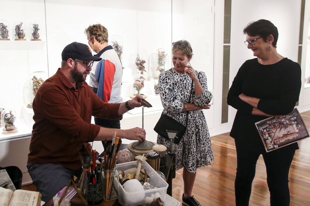 Saxon Reynolds with some of his steampunk-inspired work at the Wollongong Art Gallery. Picture: Anna Warr