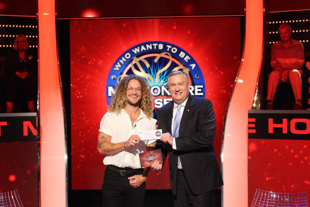 Jackson Russell with his novelty cheque from Eddie McGuire on Millionaire Hot Seat. Picture: Channel 9