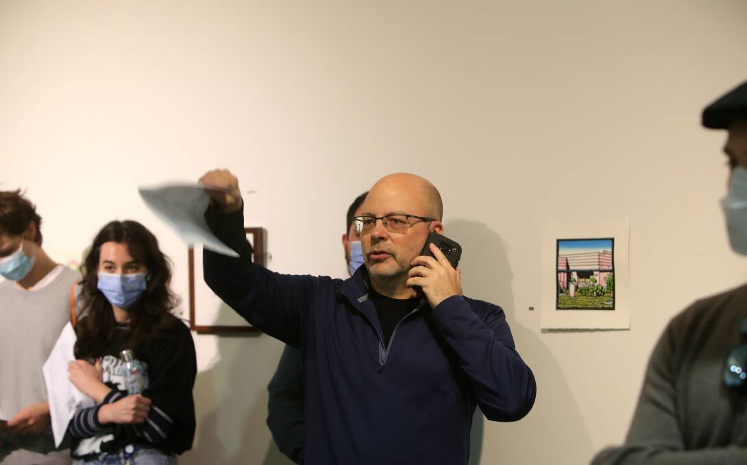 A bidder at Tuesday's UOW Art Auction with Auctioneer Joshua Lobb. Picture: Sylvia Liber