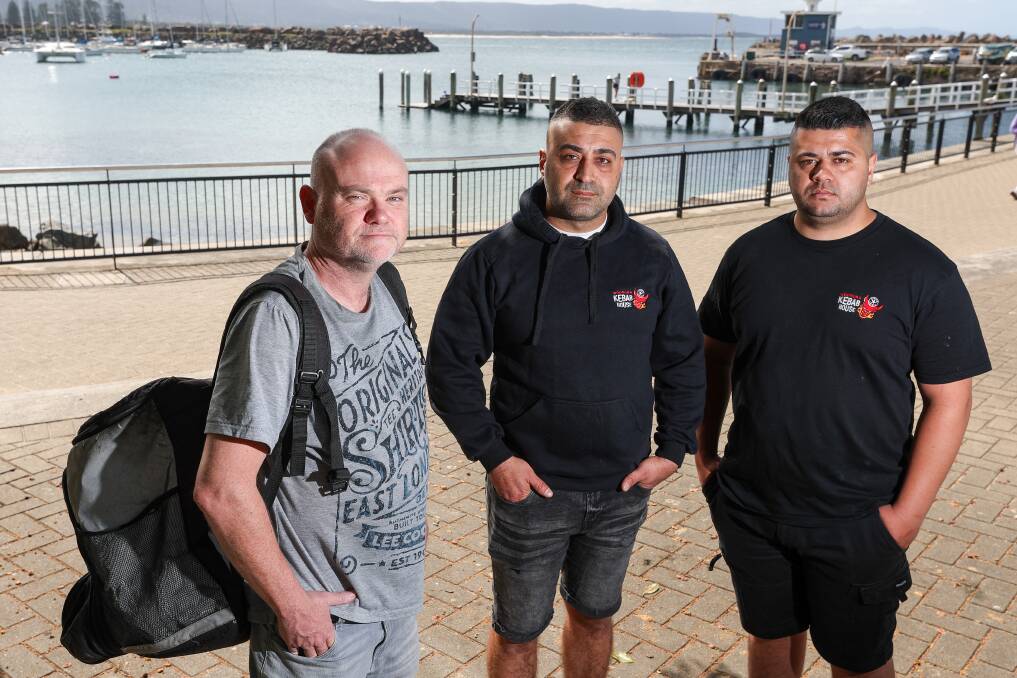 Delivery partner Paul with Woonona Kabab House owners Ali Karavacak and Ahmet Karavacak at Wollongong Harbour. Picture by Adam McLean