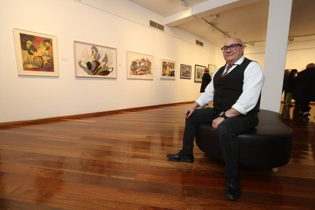 FLASHBACK: Wollongong Art Gallery director John Moneteleone in front of finalist submissions in the Flow exhibition of 2019. Picture: Robert Peet