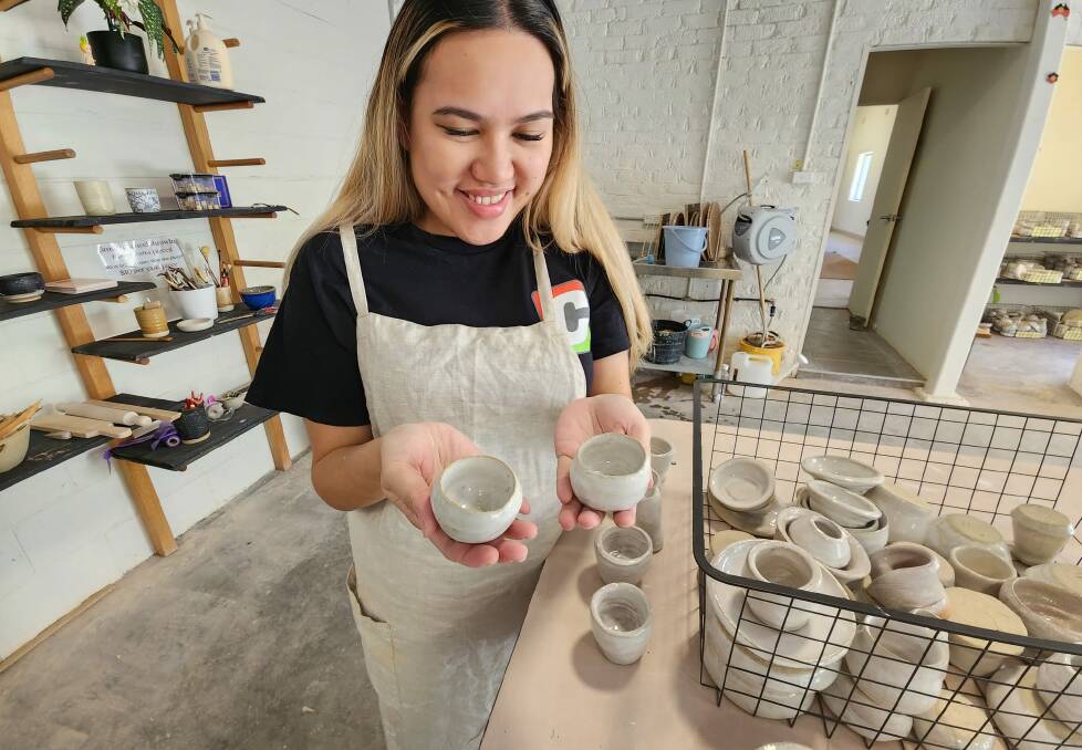 April from Clay Wollongong holding some of our class's ceramics. Picture by Desiree Savage.