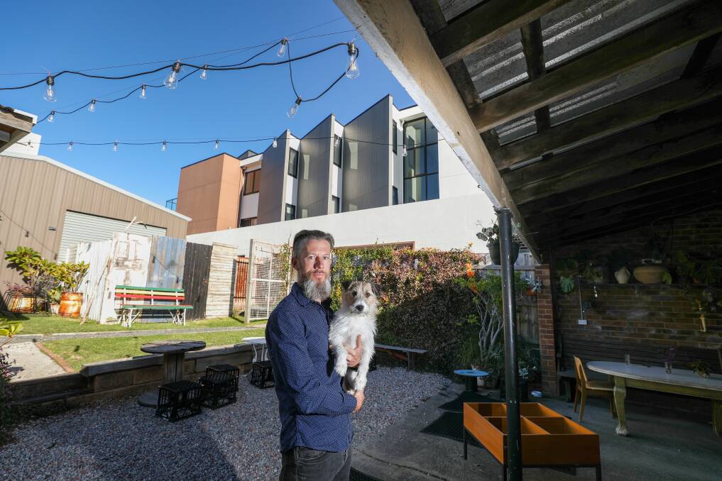 Morgan Lewis, owner of the Kiama cafe Finding Fillmores, with his dog Ted. Picture by Adam McLean.
