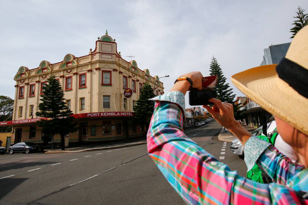 ON SHOW: A woman photographs the Port Kembla Hotel during a history tour of Port Kembla's Wentworth Street. Picture: Adam McLean