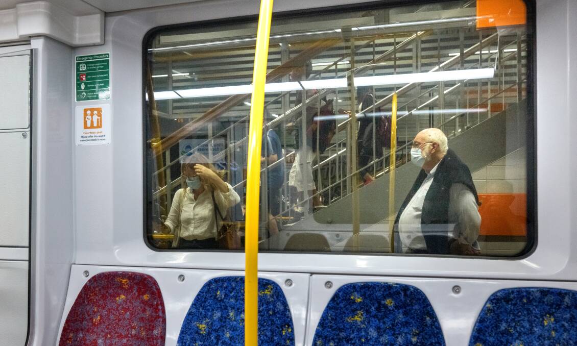 Commuters at Town Hall train station cover up as wearing masks on public transport becomes mandatory for Sydney and Greater Sydney (including Wollongong). Picture: Sitthixay Ditthavong