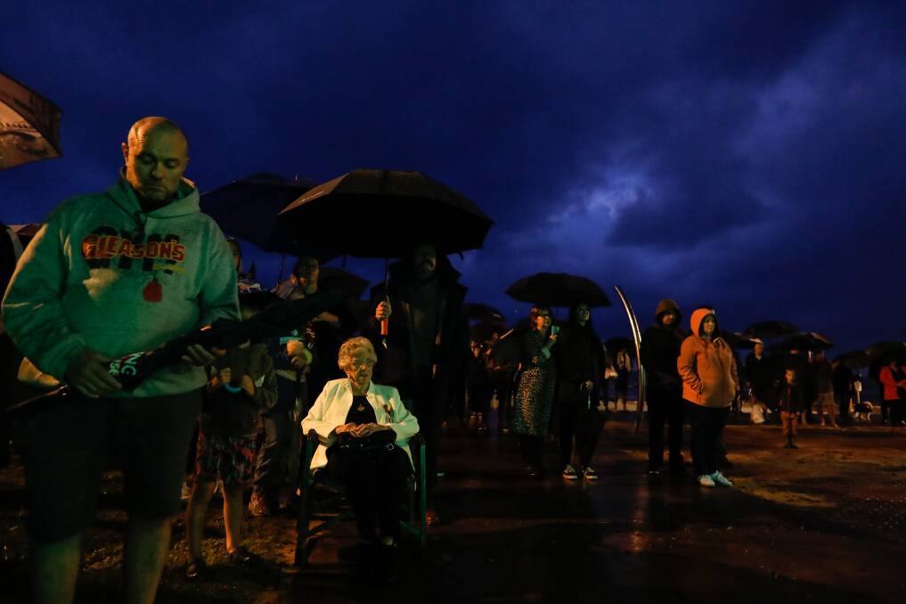 Veteran Sylvia Jones sits at the front of the Anzac Dawn Service at Austinmer Beach. Picture: Anna Warr