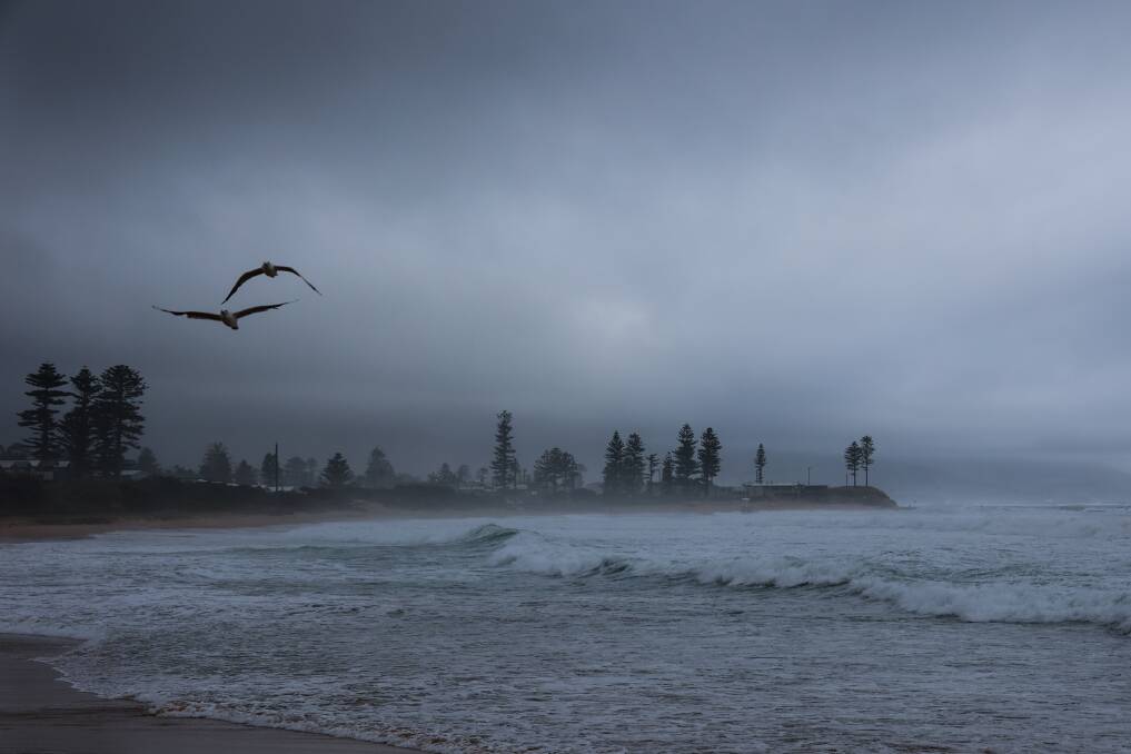 A mist and fog layer cover Bulli Beach on Wednesday morning after a run of hot summer days. Picture by Wesley Lonergan.
