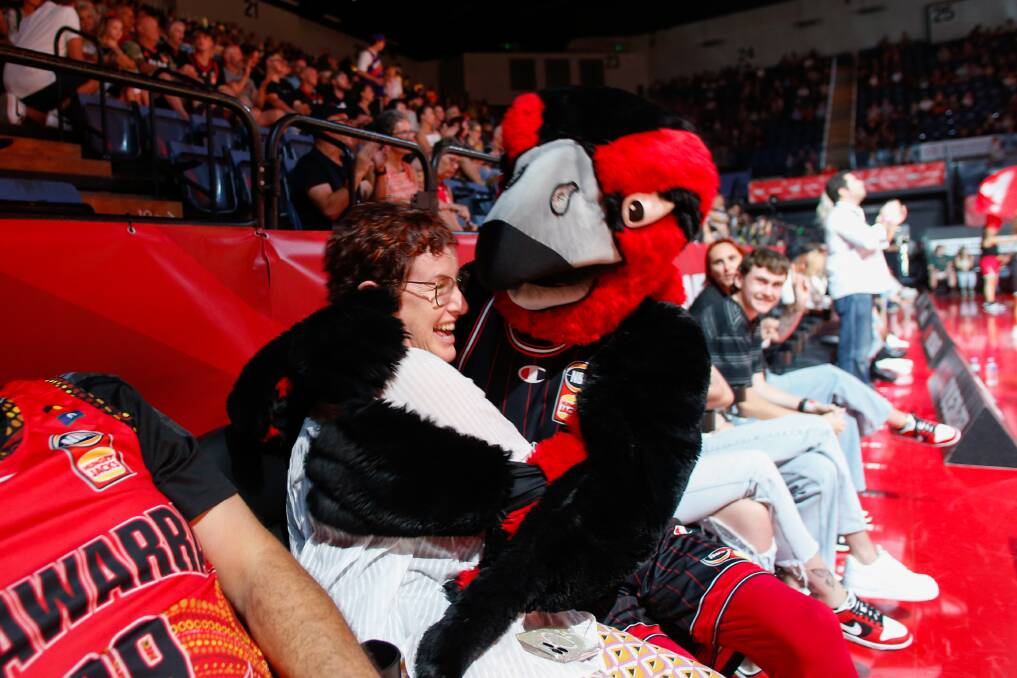 Hawks mascot Tomohawk gets friendly with a fan at the January 28 home game. Picture by Anna Warr.