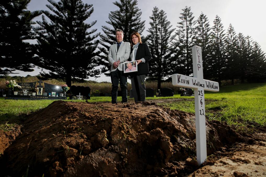Ian Carratt and Jane Carratt at the grave of Jane's father Kevin Whalan in Kiama cemetery. Kevin was a resident of the Blue Haven aged care in Kiama and recently died of COIVD-19. Picture: Adam McLean