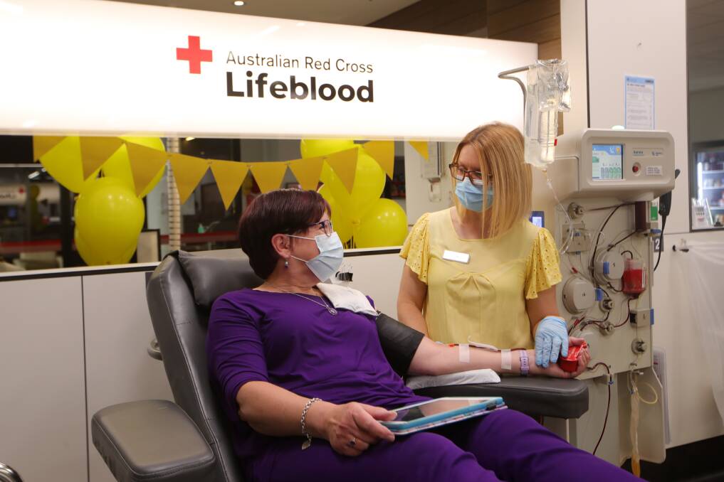 POSITIVE VIBES: Angela Lester has made 62 donations to the Wollongong Lifeblood centre and on Tuesday it was 800 ml of life-saving plasma (pictured with nurse Leigh Steel). Picture: Sylvia Liber