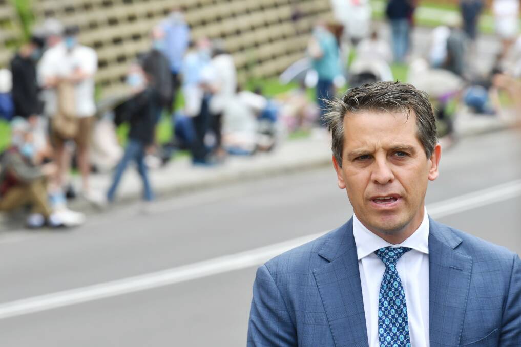 Keira MP Ryan Park addresses the media on Wednesday, across from Wollongong Hospital where queues for the COVID-19 testing clinic stretched around the block. Picture: AAP