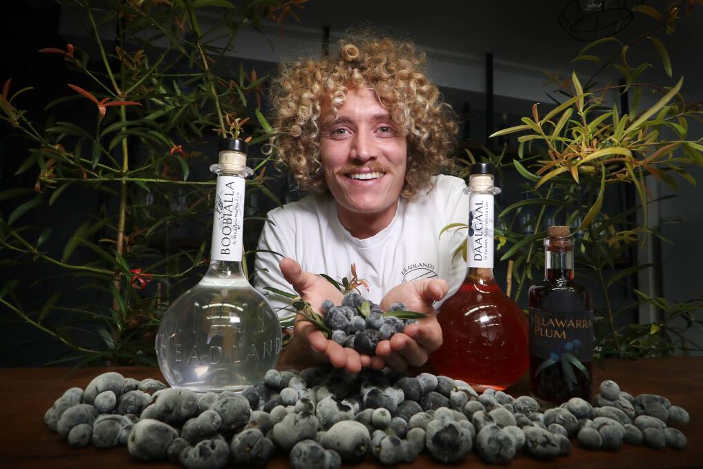 Jared Smith from Headlands Distilling Company with a bottle of their plum gin. Picture: Sylvia Liber