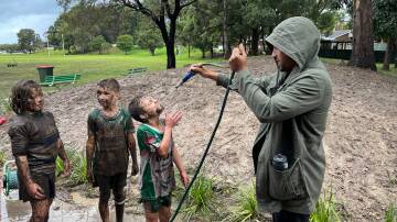SATURDAY SPORT: The Woonona Bulli Bushrangers Under 9 team get hosed down after a very muddy match on Saturday, May 21. Picture: Anna Warr