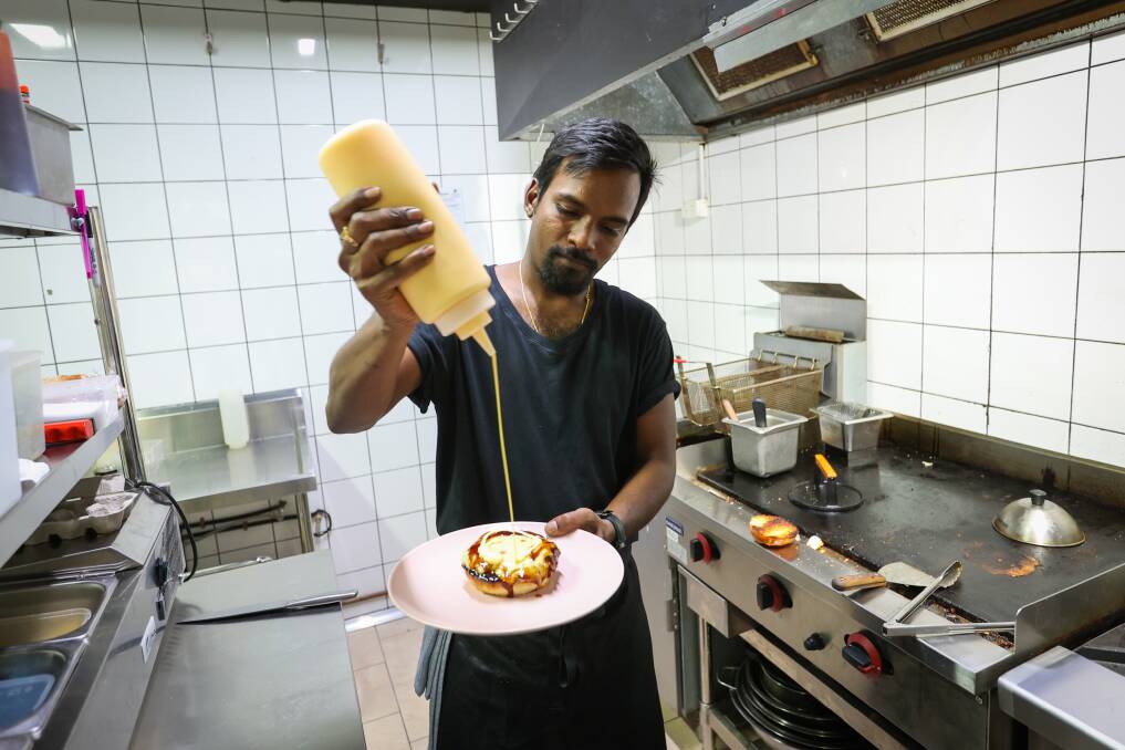Goutham Thota making one of Sauce's signature burgers. Picture by Wesley Lonergan