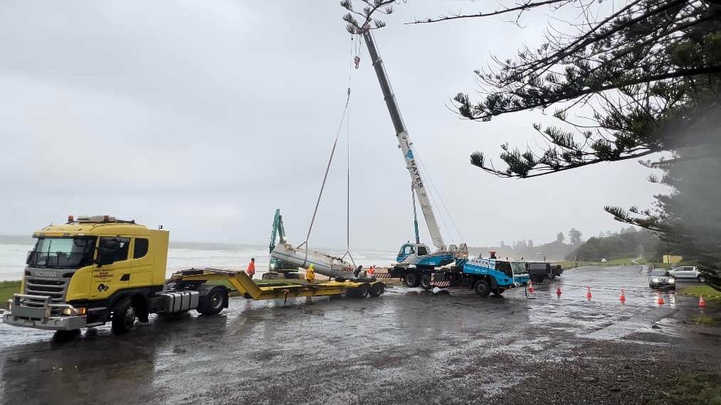 A yach that capsized near the Coledale coast in terrible conditions being craned off the beach on Tuesday. Picture: Illawarra and surrounds marine life sightings