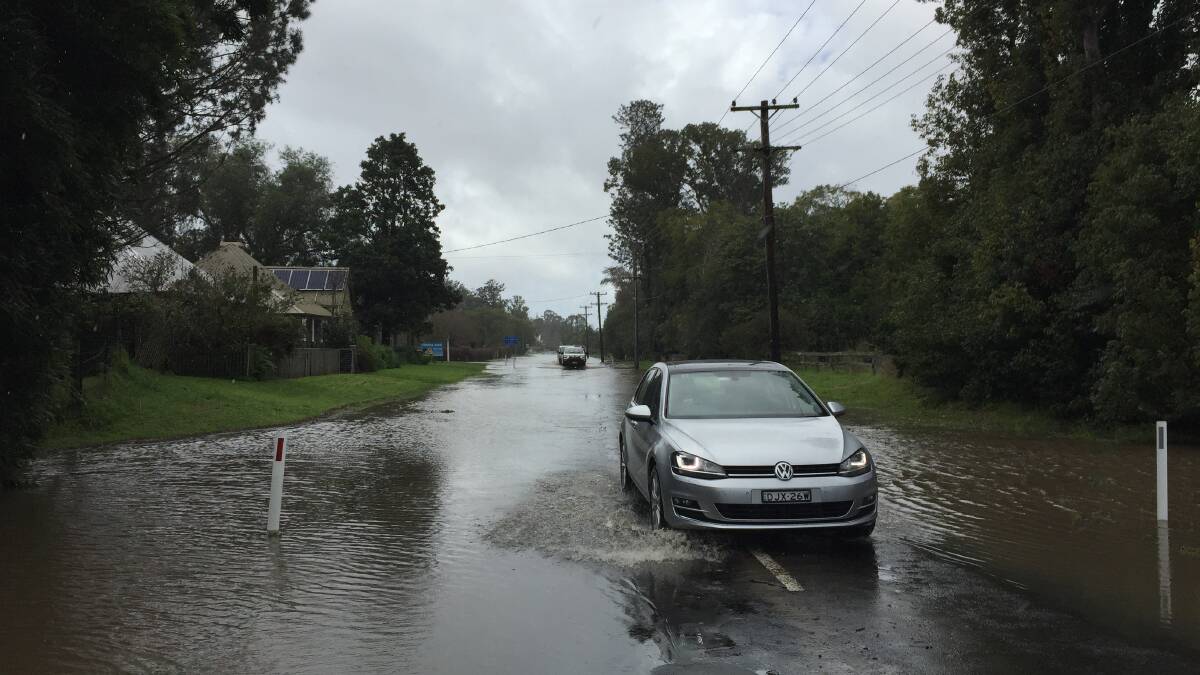 Moss Street in Terara is flooded by the rising Shoalhaven Rive on Monday. Picture: Sylvia Liber
