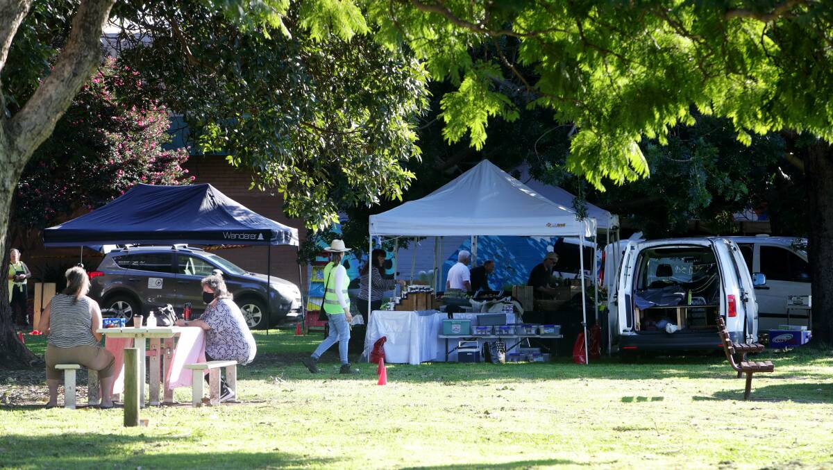 SAVED FROM EXTINCTION: Stall-holders set up for the weekly market at Corrimal Park on Wednesday morning. Picture: Sylvia Liber