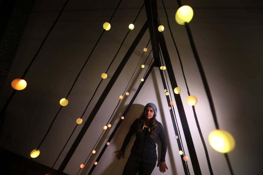 LIGHTING UP LIFE: Abhiruchi Chhikara, pictured with one of her art works, is creating light shows around the Illawarra beginning in Thirroul this weekend. Picture: Sylvia Liber