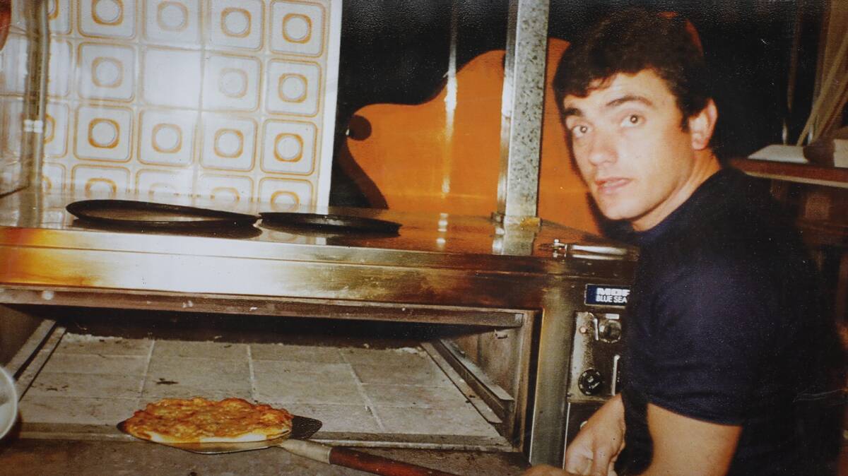 FLASHBACK: Guilio Giuliani with the first pizza he made in his Windang restaurant, Pinocchios. Picture: Supplied