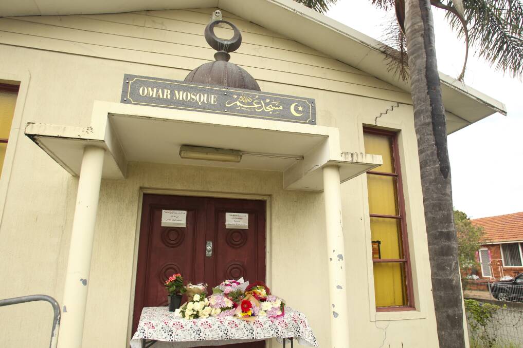 Dozens of flowers and cards left at the Omar Mosque in Gwynneville on Saturday, in tribute to the New Zealand shooting victims. Picture: Anna Warr