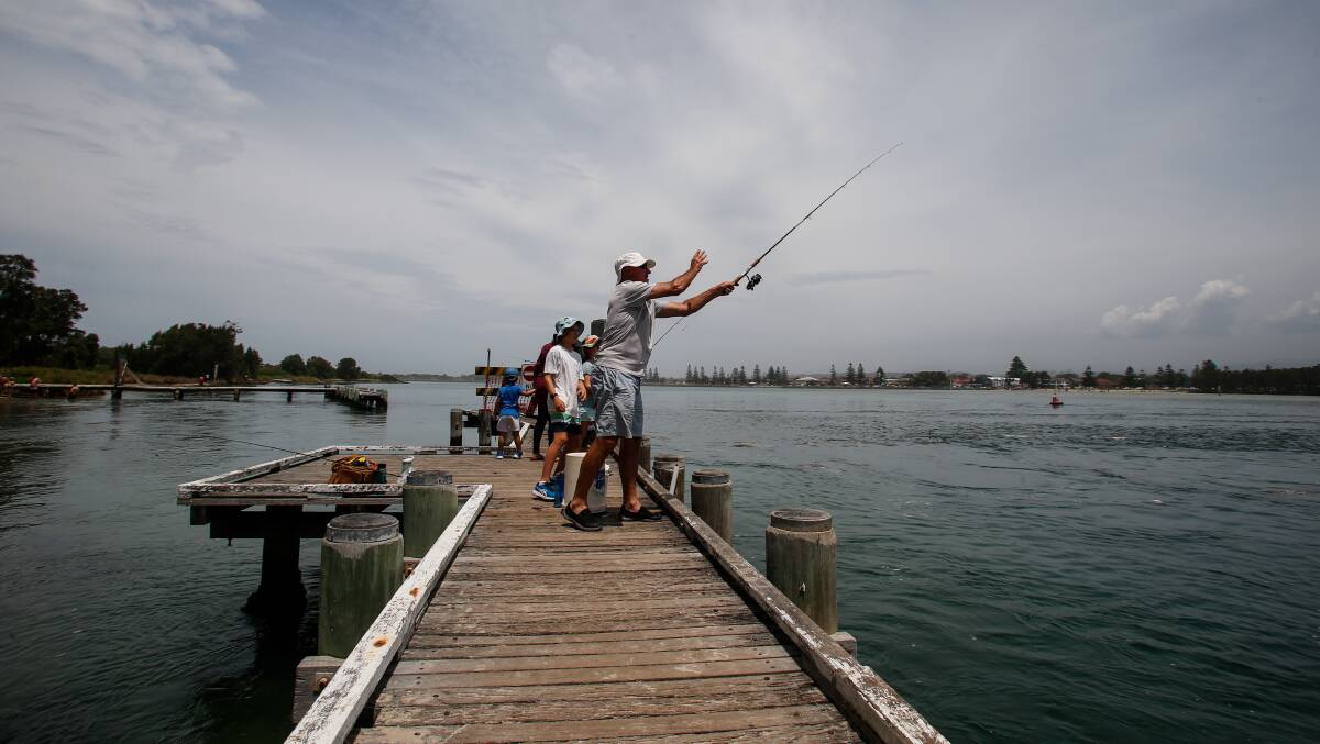 People launch their fishing lines off a Windang jetty in January 2022. Picture: Anna Warr