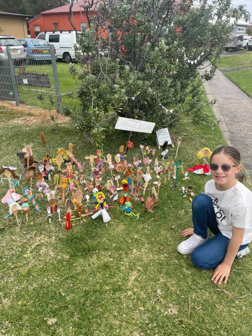 WOOD WORK: Matilda Peacock, 9, at the Spoonville pop-up on Lawrence Hargrave Drive in Thirroul. There is also a Spoonville colony in Kanahooka on Kanahooka Road. Picture: Supplied