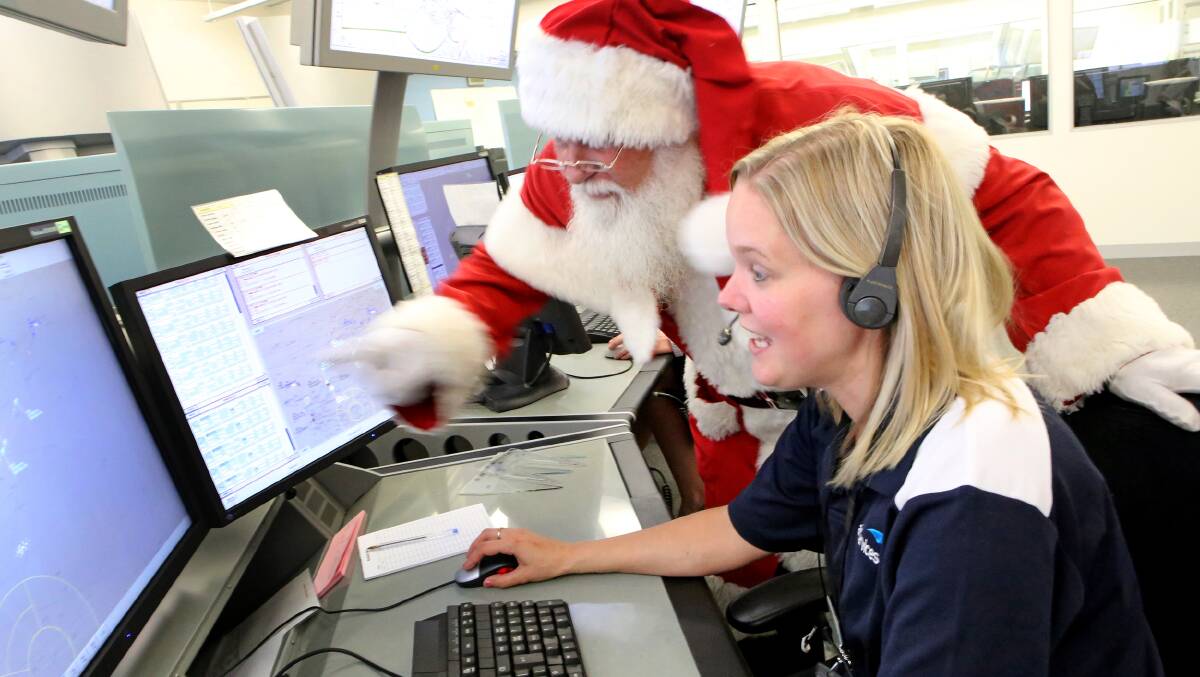 Santa checks out the Airservices Australia air traffic control facility and talks with some of the controllers who will be keeping him safe, and on time, on Christmas Eve. Picture: Airservices Australia