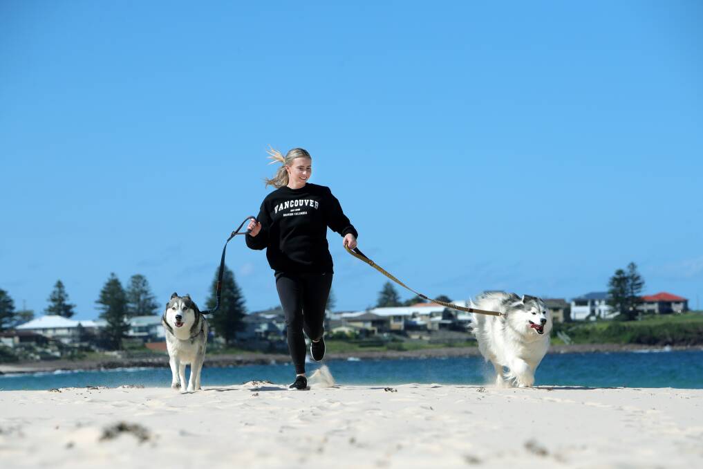 DOG'S DAY: Cassie Briggs. with Alaska and Kato, can't wait to test out the new dog beaches and parks in Shellharbour next year. Picture: Sylvia Liber