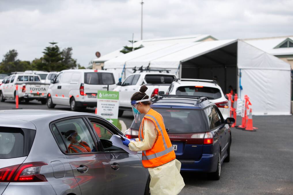 The line-up at the drive-through testing clinic on Campbell Street in Woonona on Monday. Picture: Anna Warr