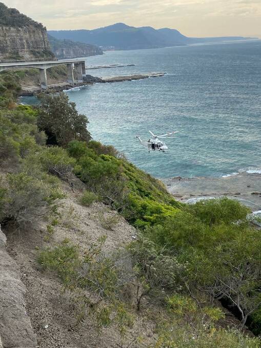 A rescue helicopter has been tasked to lower down a paramedic to assess a woman who has fallen and sustained a head injury whilst walking under the Sea Cliff Bridge on Sunday. 