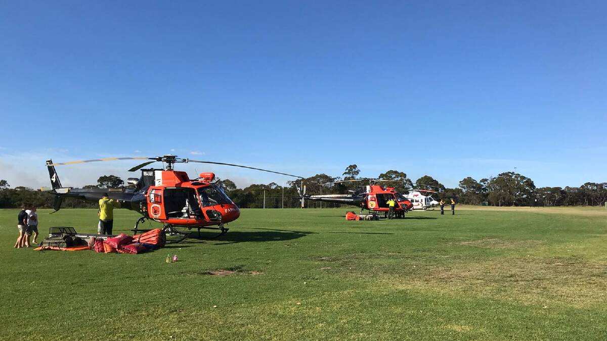 Helicopters at Heathcote preparing to take firefighters to the fire ground on Sunday. Picture: NSW National Parks and Wildlife Service
