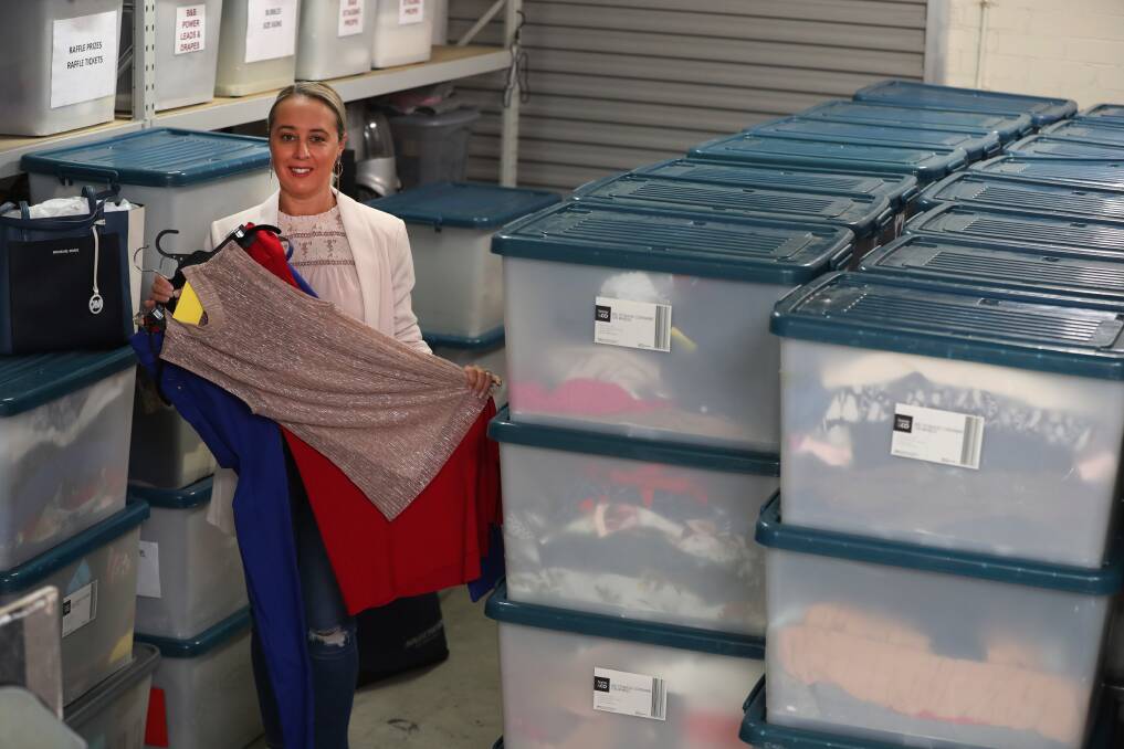 MERC, NEWS, DRESSED FOR SUCCESS Pic taken 23rd June 2022 of Bonnie Comber from Dressed For Success at Port Kembla. RE, Bonnie with dozens of tubs of clothes ready to be shipped out for its big fundraiser on Sunday at The Fraternity Club. Picture: Robert Peet