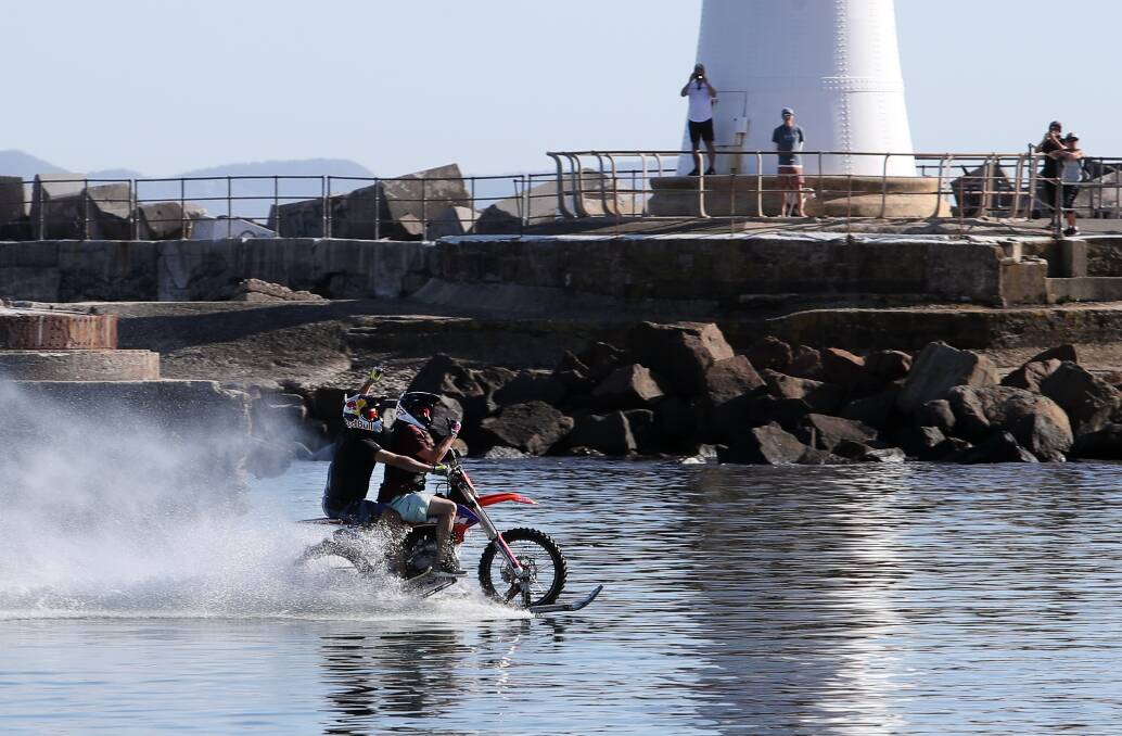 Robbie Maddison, with passenger James Tobin, riding across Belmore Basin, part of the Destination Wollongong/Tourism Week, Press Play breakfast in 2019. Picture by Robert Peet