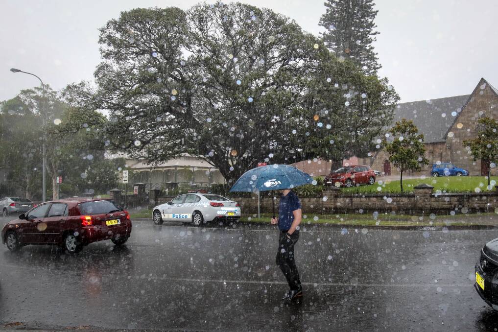 People going through Wollongong CBD as a storm hits on Thursday afternoon. Picture: Adam McLean

