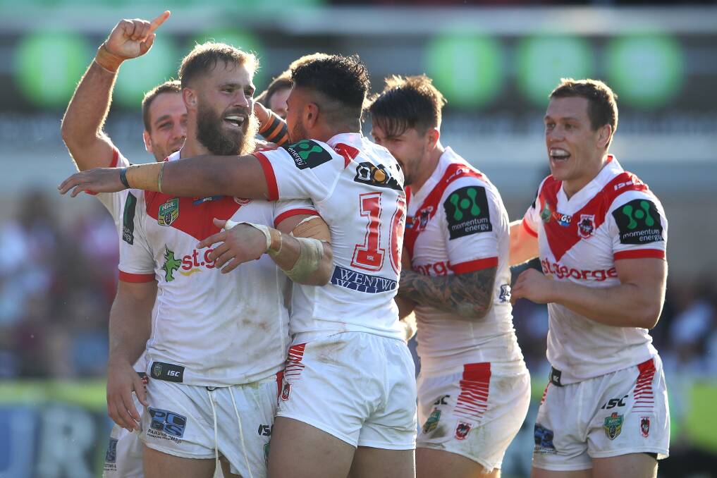 WINNING FEELING: Teammates embrace try-scorer Jack de Belin in the Dragons round-six win over Manly. Picture: Getty Images