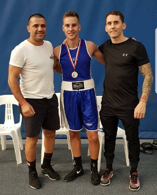 TITLE CHASE: Rising Illawarra boxer Thomas Glancy (centre), with coaches Brian Banco (left) and Mitch Brisbane (right), will fight for his first amateur title on Saturday.