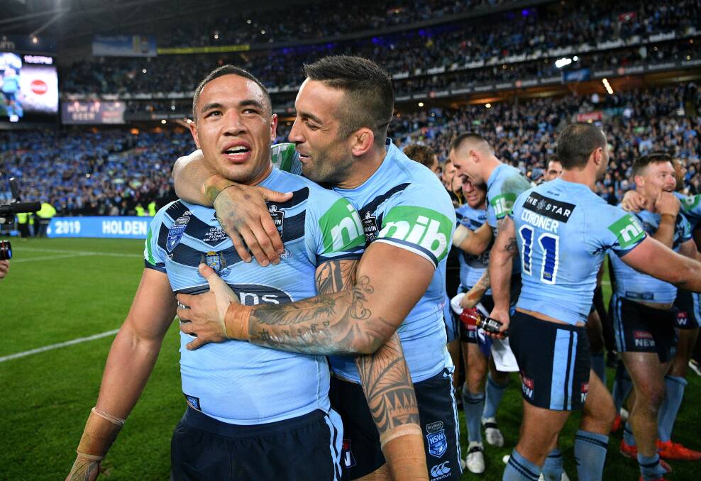 SWEET: Dragons teammates Tyson Frizell and Paul Vaughan celebrate the Blues Origin series win on Wednesday. Picture: NRL Photos