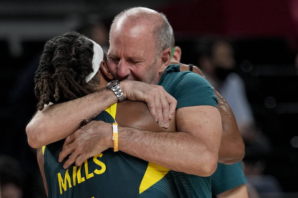 BOND: Brian Goorjian and Patty Mills embrace after claiming bronze in Tokyo. Picture: AP