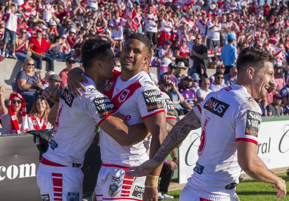 WINNING FEELING: Dragons players celebrate Tim Lafai's try against Melbourne on Sunday. Picture: AAP