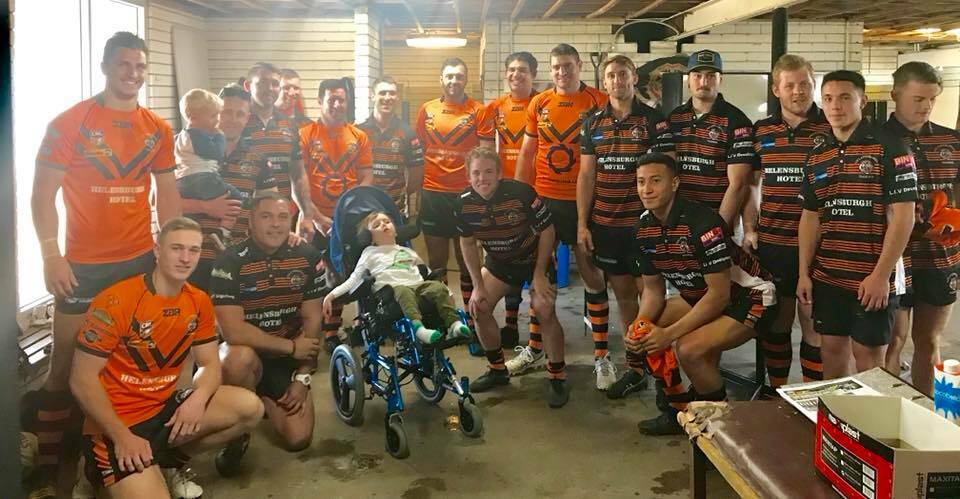 HELPING HAND: Helensburgh's first-grade side will ear special Wiggles-inspired jumpers on Saturday in support of their biggest fan young Caleb Clarke (centre).