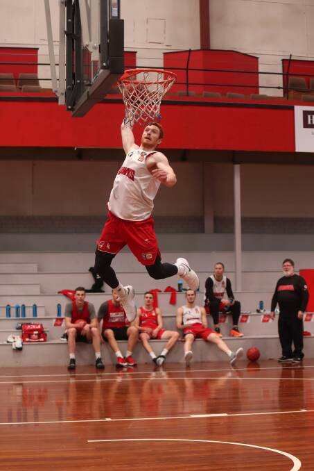 FLYING HIGH: "I haven't been tentative on my knee once." Hawks guard Angus Glover goes aerial at the Snakepit. Picture: Sylvia Liber
