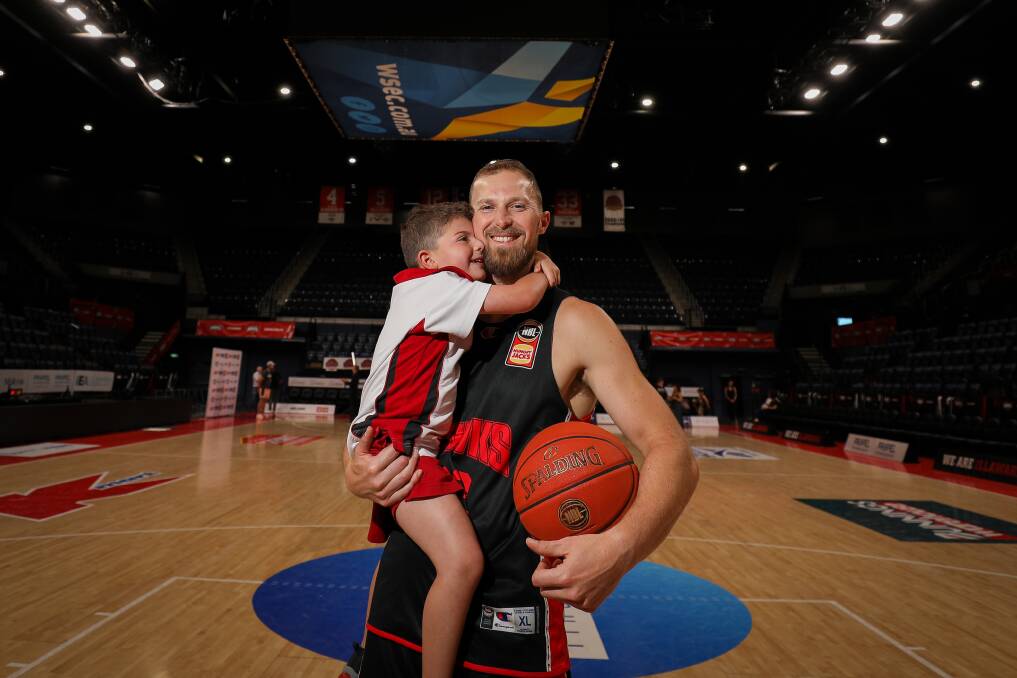 Retiring Hawks stalwart Tim Coenraad with son Tyson ahead of his final game for the club. Picture by Adam McLean