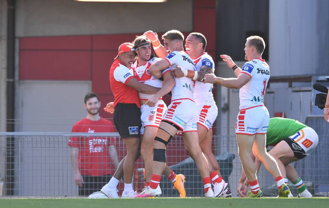 HOW GOOD: Cody Ramsey is mobbed after scoring on debut against the Raiders on Saturday. Picture: NRL Imagery