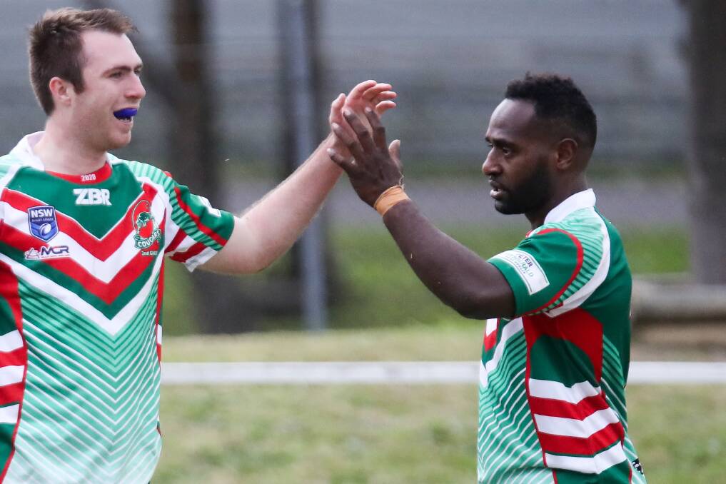 HIGH FIVE: Cougars halfback Benton Pyako (right) has already developed a cult following. Picture: Adam McLean