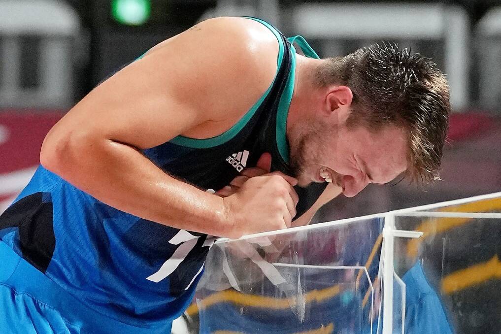 OUCH: Slovenian superstar Luka Doncic suffered a wrist injury in a court-side mishap during his team's semi-final loss to France on Thursday night. Picture: AP